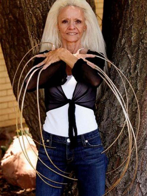 Lee Redmond shows off her fingernails, which are about 30 inches long. Redmonds fingernails were...