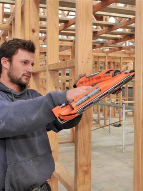 Leon Peirce (19) a building apprentice with Mark Fairweather Builder, works on a new house on...