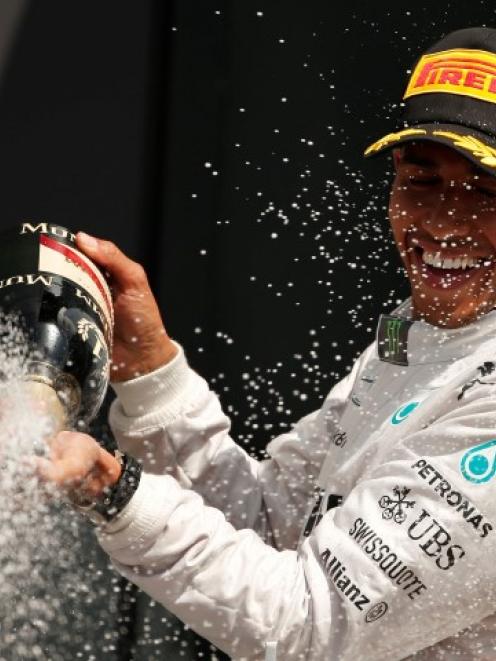 Lewis Hamilton sprays Champagne as he celebrates winning the British Grand Prix at the...