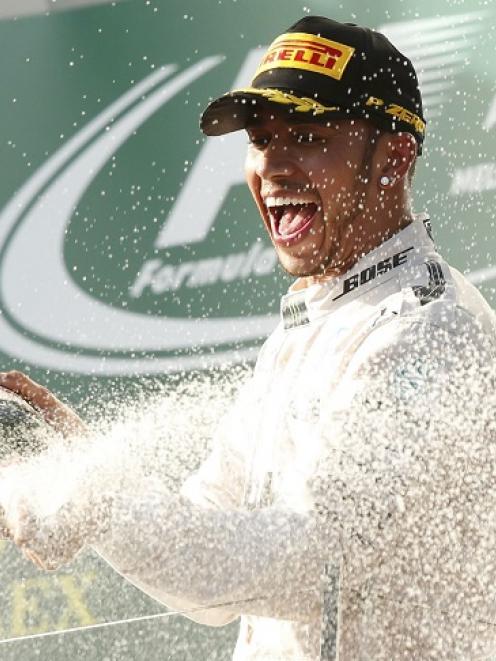 Lewis Hamilton sprays champagne on the podium after the Australian F1 Grand Prix at the Albert...