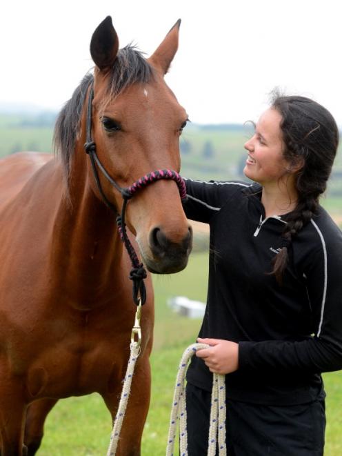 Lexie Elliott with her horse Jay in the paddock at home in Palmerston. Photo by Linda Robertson.