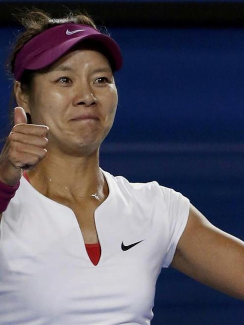 Li Na of China celebrates defeating Dominika Cibulkova.      REUTERS/Jason Reed