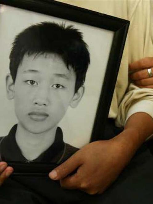 Liao Mengjun (15) died at his school in Foshan, China, with officials alleging suicide. His...