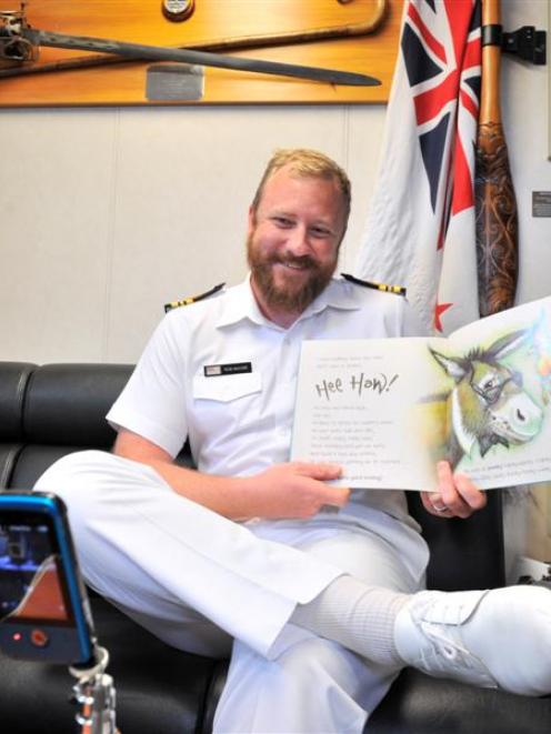 Lieutenant-commander Rob McCaw records himself reading children's books on HMNZS Otago, to send...