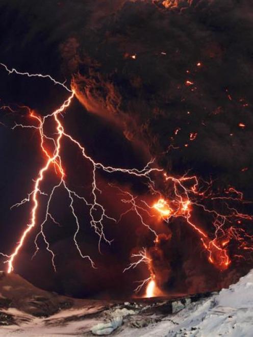 Lightning streaks across the sky as lava flows from a volcano in Eyjafjallajokul on Sunday.