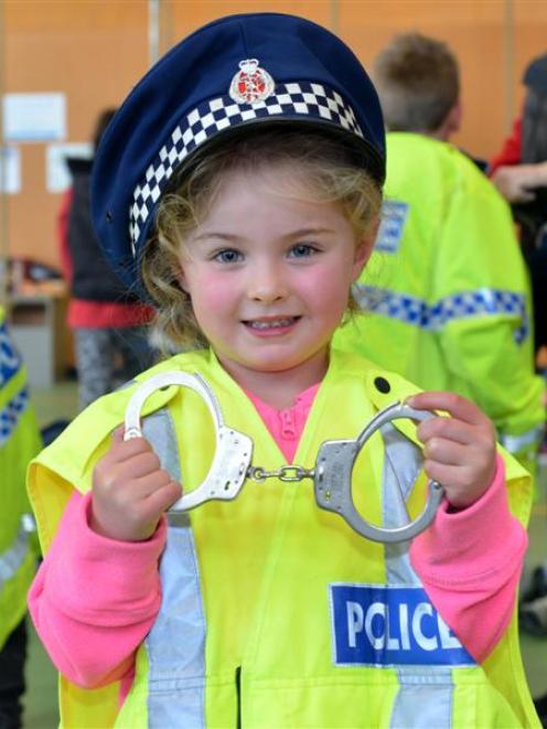 Lilly Georgeou (5) tries on a police uniform during the National Police Open Day at the Dunedin...