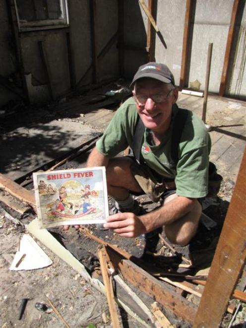 Lindsay Bellamy, of Bagley Builders, holds a 59-year-old book on the Ranfurly Shield found in a...