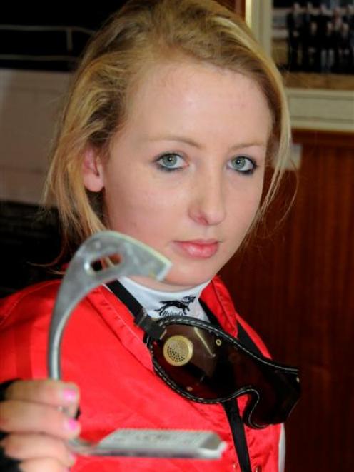 Lisa McKay with the broken stirrup iron. Photo by Tayler Strong.