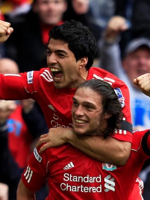 Liverpool's Andy Carroll (bottom) celebrates his goal against Everton with teammate Luis Suarez...
