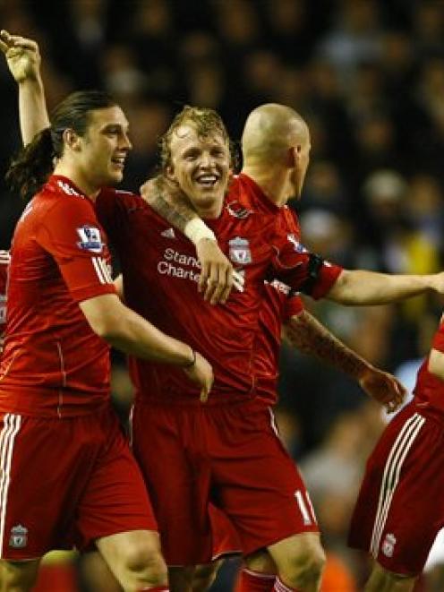 Liverpool's Dirk Kuyt, centre, is congratulated by team-mates after scoring a goal against...