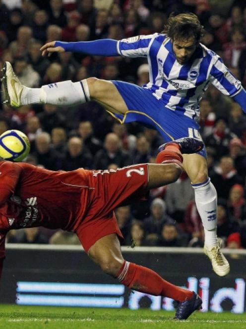 Liverpool's Glen Johnson challenges Brighton and Hove Albion's Ingo Calderon. REUTERS/Phil Noble