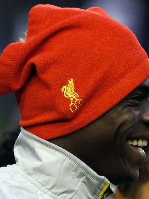 Liverpool's Mario Balotelli smiles during a training session at Anfield in Liverpool, northern...