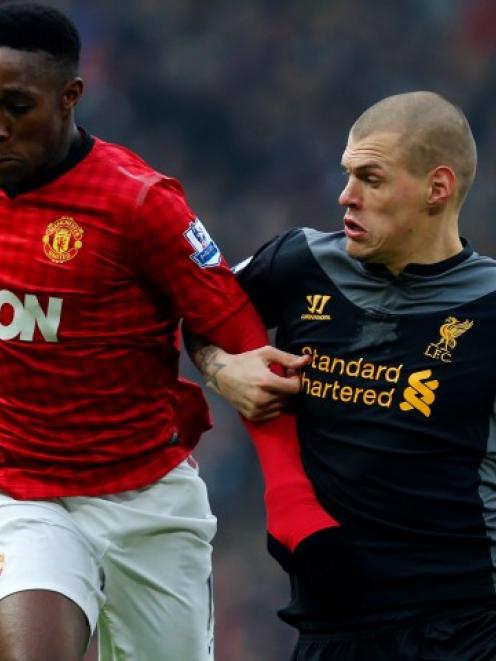 Liverpool's Martin Skrtel (R) challenges Manchester United's Danny Welbeck during their English...