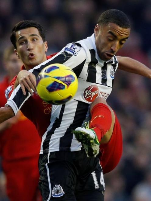 Liverpool's Nuri Sahin (L) challenges Newcastle United's James Perch during their English Premier...