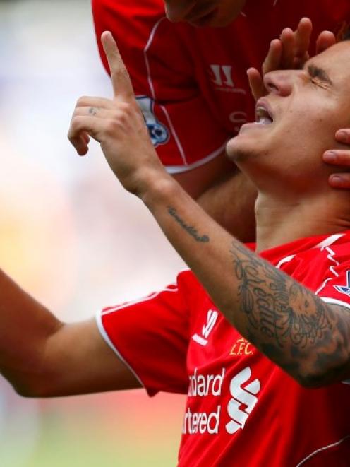 Liverpool's Philippe Coutinho celebrates scoring against Queens Park Rangers at Loftus Road in...