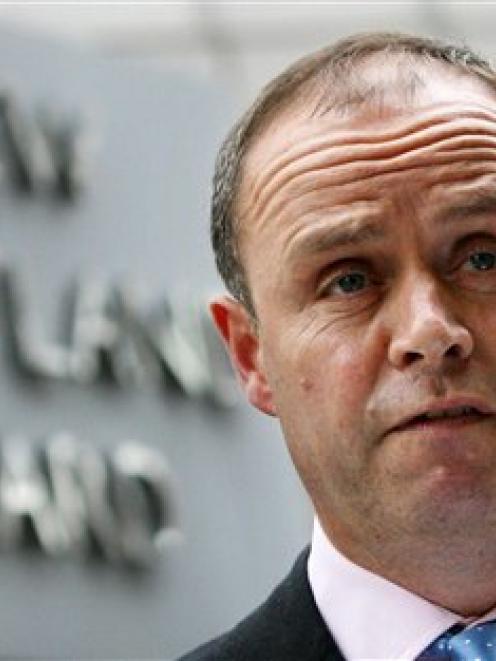 London's Metropolitan Police Assistant Commissioner John Yates stands outside the force's...