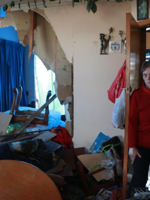 Louise Daley inspects the devastation where a car smashed into her Orwell St, Oamaru, home. Photo...