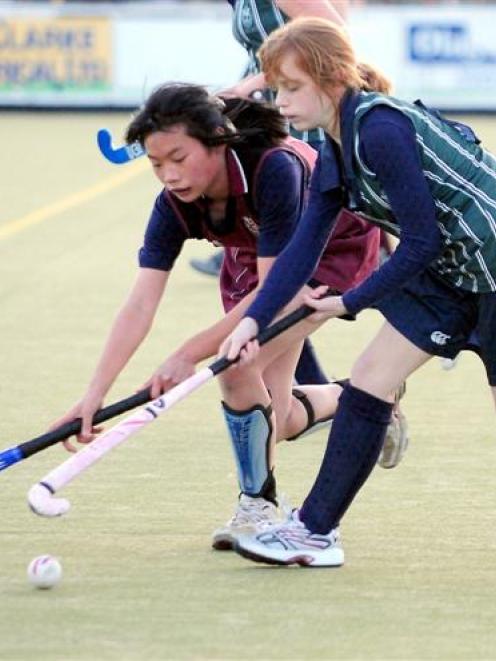 Louise Lin (Logan Park), left, and Connie McDonald (Columba) battle for possession in a secondary...