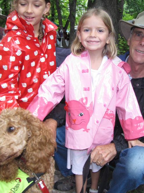 Loulou (8) and Yasmine Regos (5) with apricot poodle Fritta and canine handler Grant Reid of the...