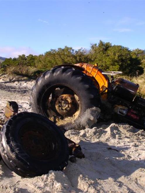 Lucas Vorgers surveys the remains of the tractor  from which he hopes to salvage parts. Photo by...