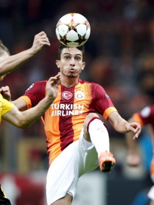 Lukasz Piszczek of Borussia Dortmund (L) challenges Alex Telles of Galatasaray during their...