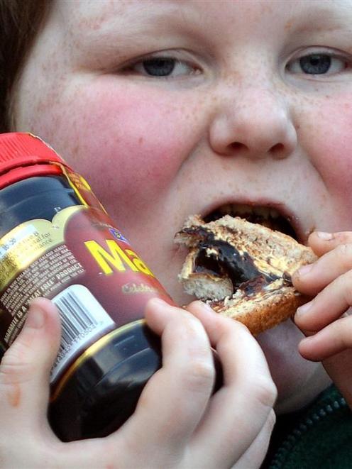 Luke Bain, of Dunedin, tucks into a Marmite sandwich. Photo by Peter McIntosh.
