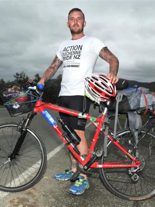 Luke O'Malley stops near Outram to visit family yesterday, as part of his cycling mission from...