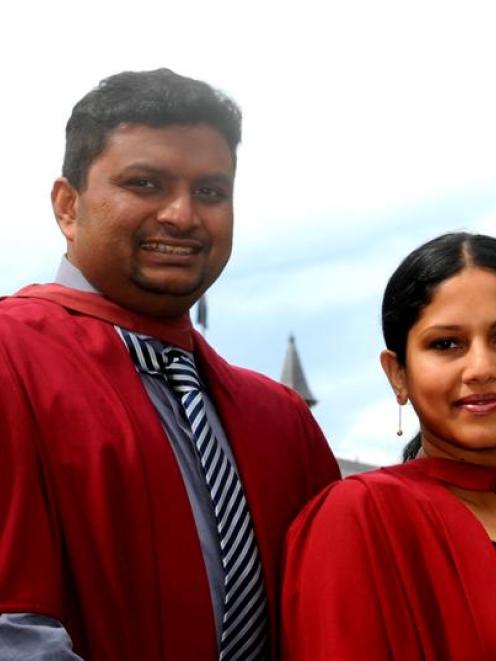 Luxmanan Selvanesan and his wife, Carthika Luxmanan, prepare to graduate from the University of...
