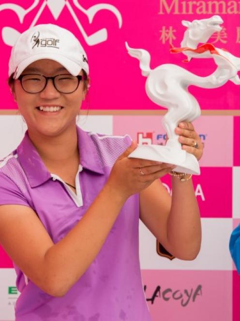 Lydia Ko poses with the trophy after her win. Photo Getty Images
