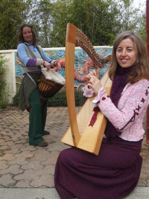 Lynley Caldwell plays her harp while Ra McRostie practices her drumming. Photo by Sally Rae.