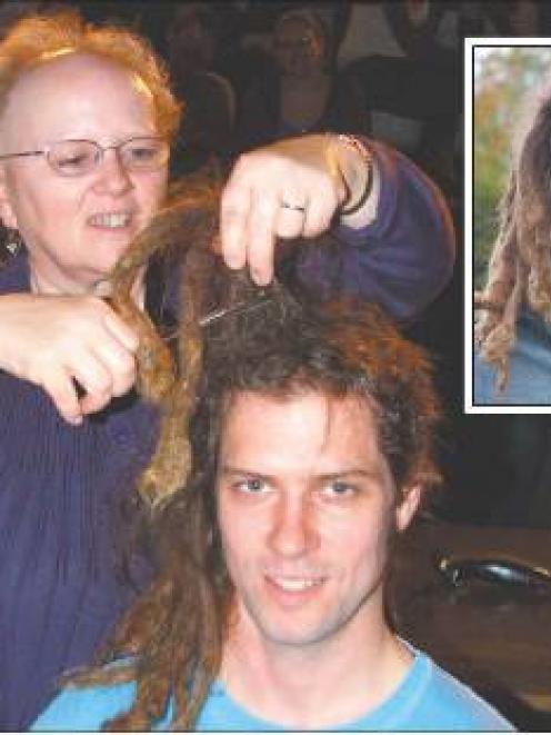 Lysiane Dufour cuts dreadlocks from the head of Matthew Crane, who was raising Heart Foundation...