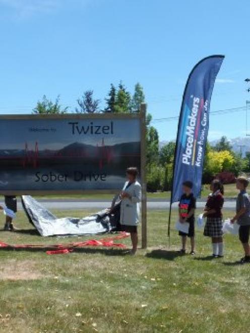 Mackenzie Mayor Claire Barlow unveils the Twizel Area School Sadd group's sign in November last...