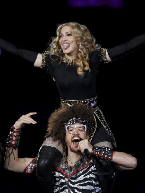 Madonna performs during the Super Bowl halftime show with Redfoo, aka Stefan Kendal Gordy of...