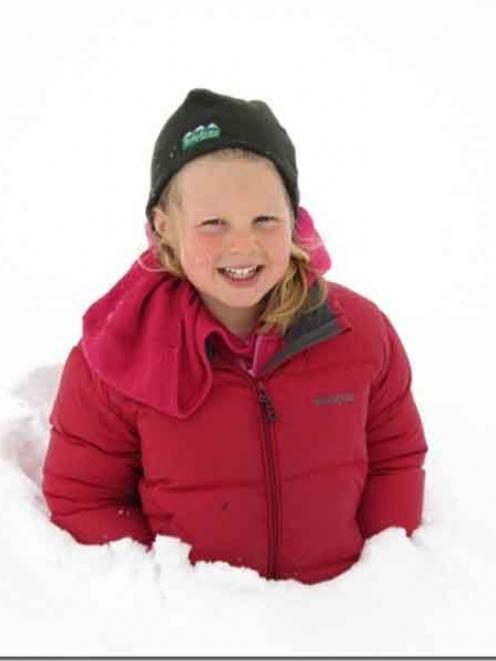 Maggie Dowling (4) in a snowdrift at Naseby. Up to a metre of snow was built up around the fences...