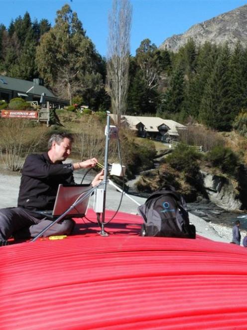 Magic Memories technician Andy Bond installs a digital receiver on the roof of the Shotover Jet...