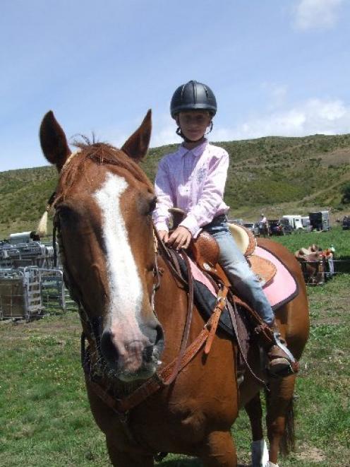 Makenzie Causer and Dawson prepare for the junior barrel race event at the Omarama rodeo on...