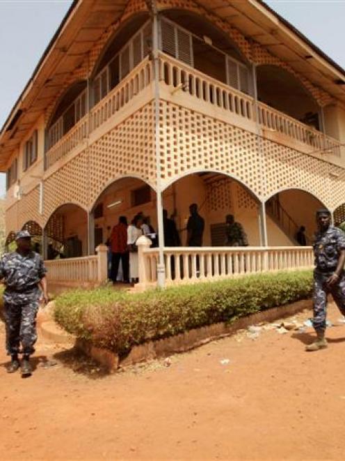 Malian junta soldiers walk in the yard of their headquarters in Kati, outside Mali's capital...