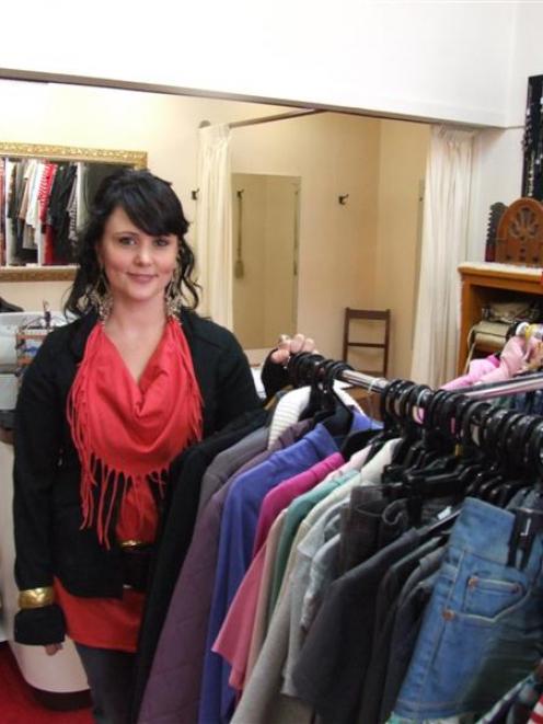 Manager Yvonne Shields prepares to welcome customers to the Inside Out clothing store, one of 10...