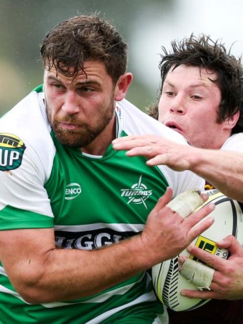 Manawatu's Callum Gibbins tries to beat the tackle of Southland's Tim Boys. Photo by Getty