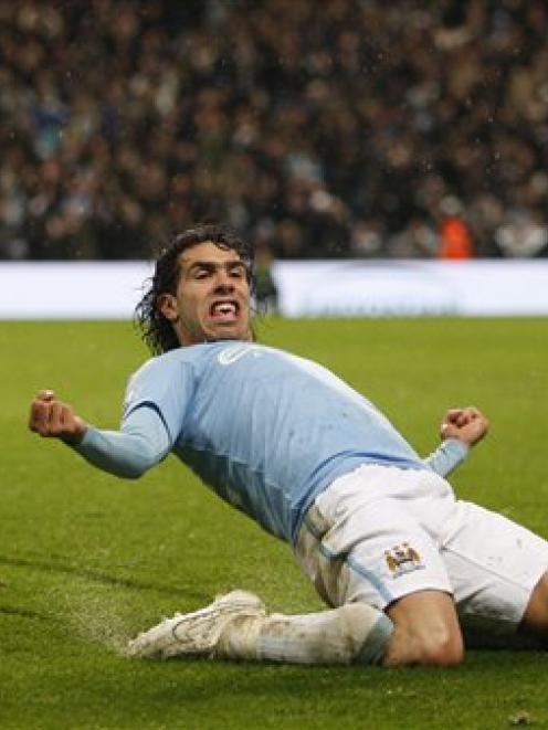 Manchester City's Carlos Tevez celebrates after scoring against Chelsea during their English...