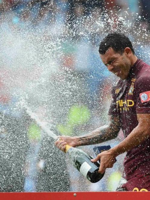 Manchester City's Carlos Tevez celebrates his team's victory over Chelsea in their English...