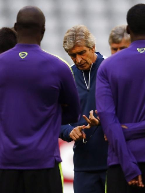 Manchester City's coach Manuel Pellegrini conducts a training session before their Champions...