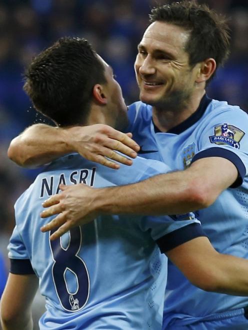 Manchester City's Frank Lampard (R) celebrates his goal with teammate Samir Nasri during their...