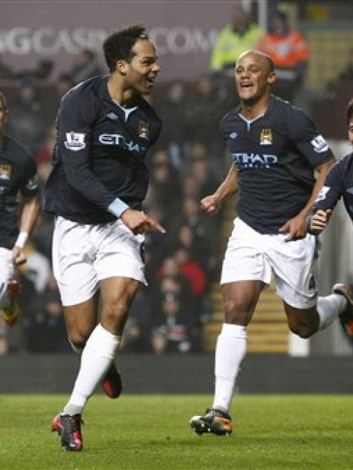 Manchester City's Joleon Lescott celebrates after scoring against Aston Villa. (AP Photo/Jon Super)