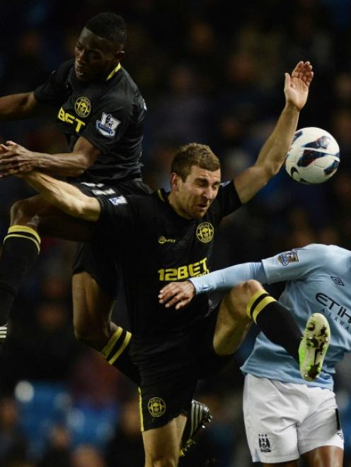 Manchester City's Scott Sinclair (right) is challenged by Wigan Athletic's Maynor Figueroa (left)...
