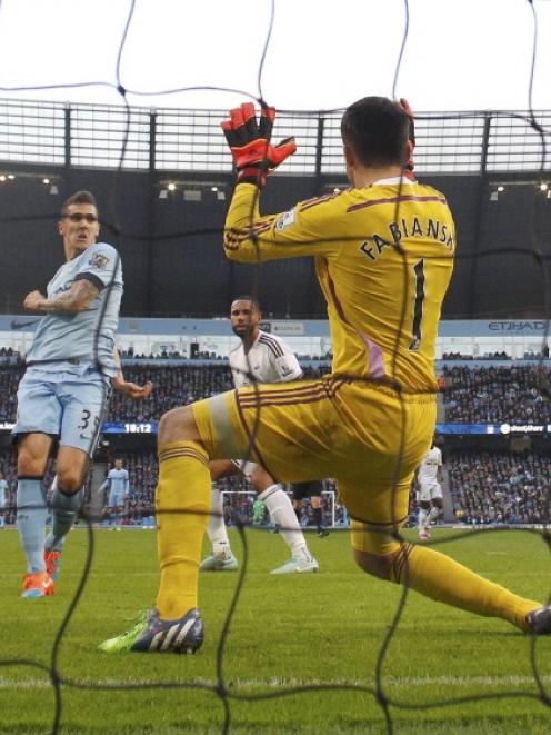 Manchester City's Stevan Jovetic (left) shoots to score a goal against Swansea City during their...