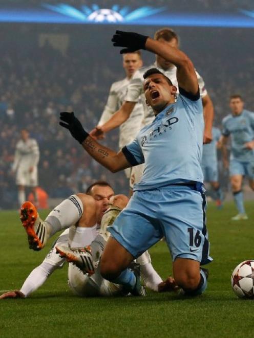 Manchester's City's Sergio Aguero falls in the penalty area during their Champions League match...