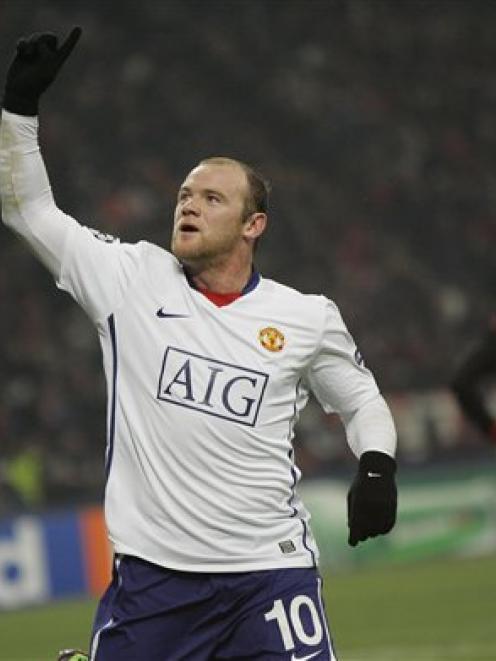 Manchester United forward Wayne Rooney celebrates after scoring during a Champions League, round...