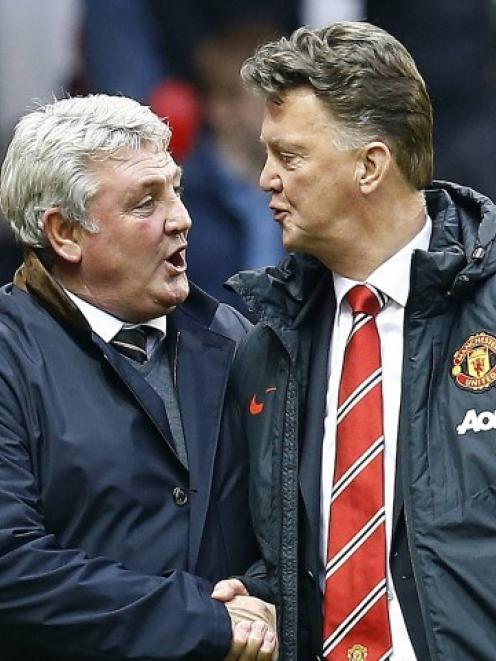 Manchester United manager Louis van Gaal (R) welcomes his Hull City counterpart Steve Bruce...