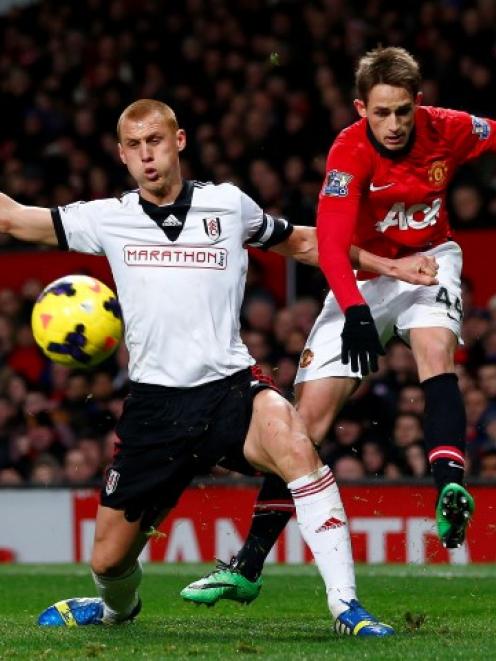 Manchester United's Adnan Januzaj (R) challenges Fulham's Steve Sidwell. REUTERS/Darren Staples